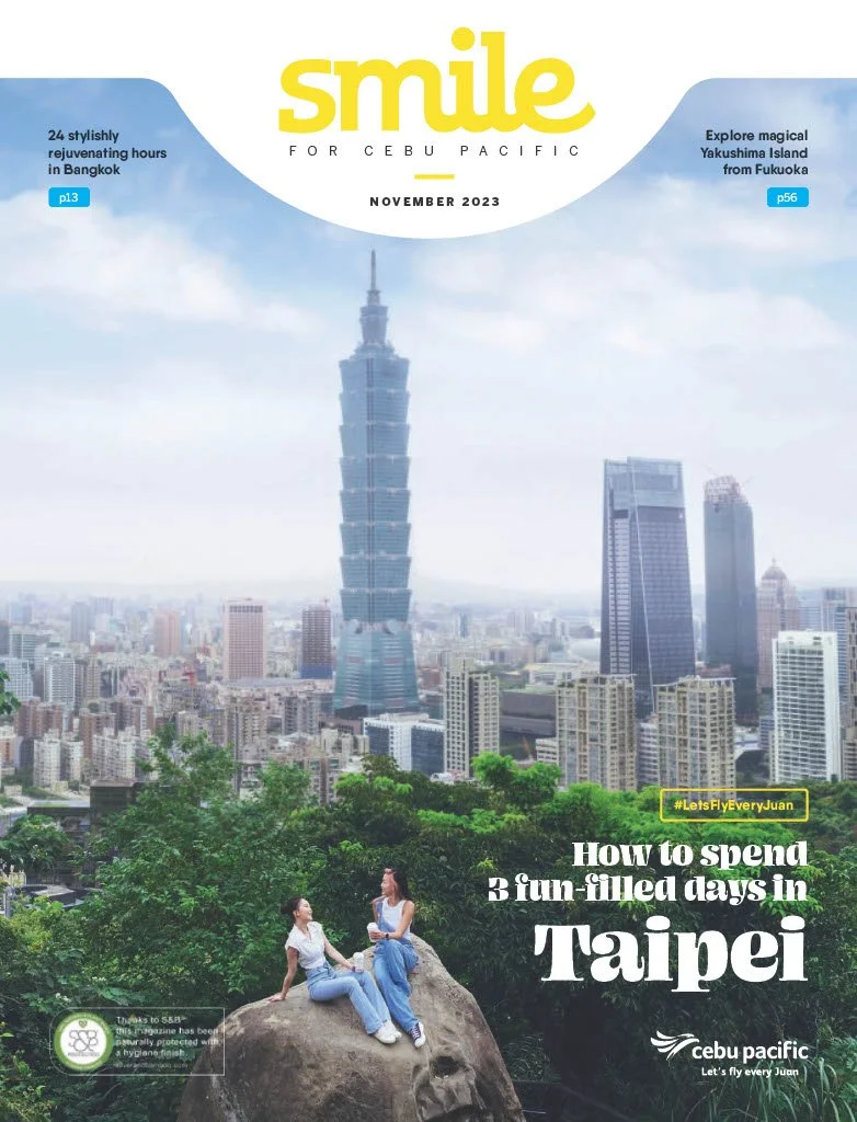 Cover of Smile magazine, November 2023. Features Taipei's skyline with Taipei 101 and two women sitting on a rock at a park, with cityscape and blue sky in background. Highlights include articles about Bangkok, Yakushima Island, and Taipei travel tips.