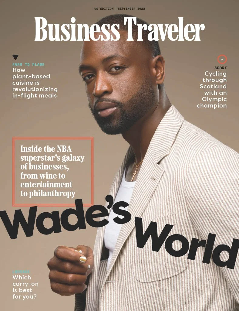Front cover of Business Traveler magazine, September 2022 edition, featuring NBA superstar Wade in a beige pinstripe suit with a serious expression, holding a ring in his hand, with headlines about plant-based cuisine, cycling in Scotland, and Wade's business ventures.