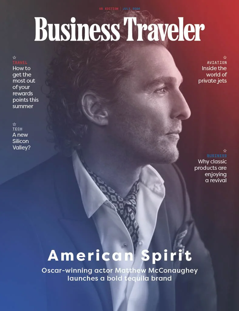 Cover of Business Traveler magazine featuring a close-up profile of actor Matthew McConaughey with a serious expression, dressed in a suit and patterned tie, against a gradient background. Headlines include topics on travel rewards, private jets, Silicon Valley, revival of classic products, and McConaughey launching a tequila brand.