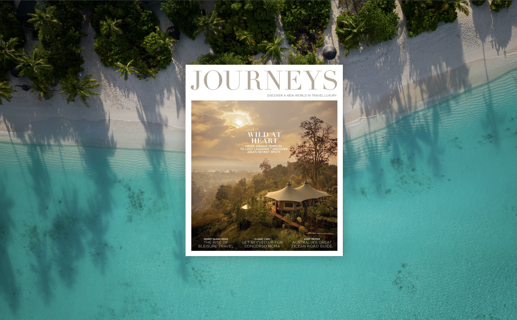 Cover of a travel magazine titled 'Journeys' overlaid on an aerial view of a tropical beach with blue ocean, white sand, and green palm trees.