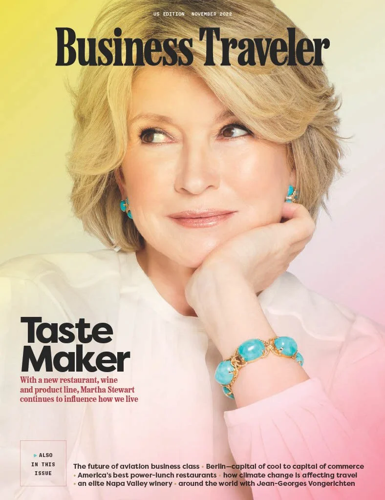Cover of Business Traveler magazine, November 2022 issue featuring Martha Stewart with blond hair, wearing turquoise jewelry, resting chin on hand, smiling, light background.