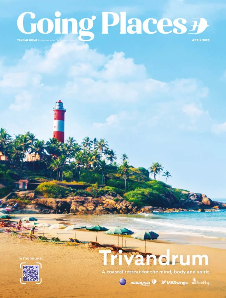A magazine cover featuring a beach scene with a lighthouse, palm trees, umbrellas, and rocks, promoting a coastal retreat at Trivandrum, Malaysia.
