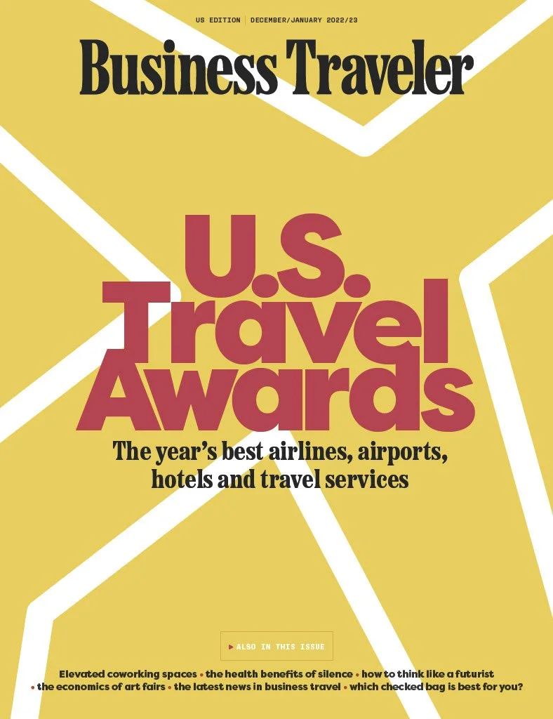 Cover of Business Traveler magazine, December/January 2022/23 issue, featuring the U.S. Travel Awards with trophy illustrations, yellow and white background, and black and maroon text.