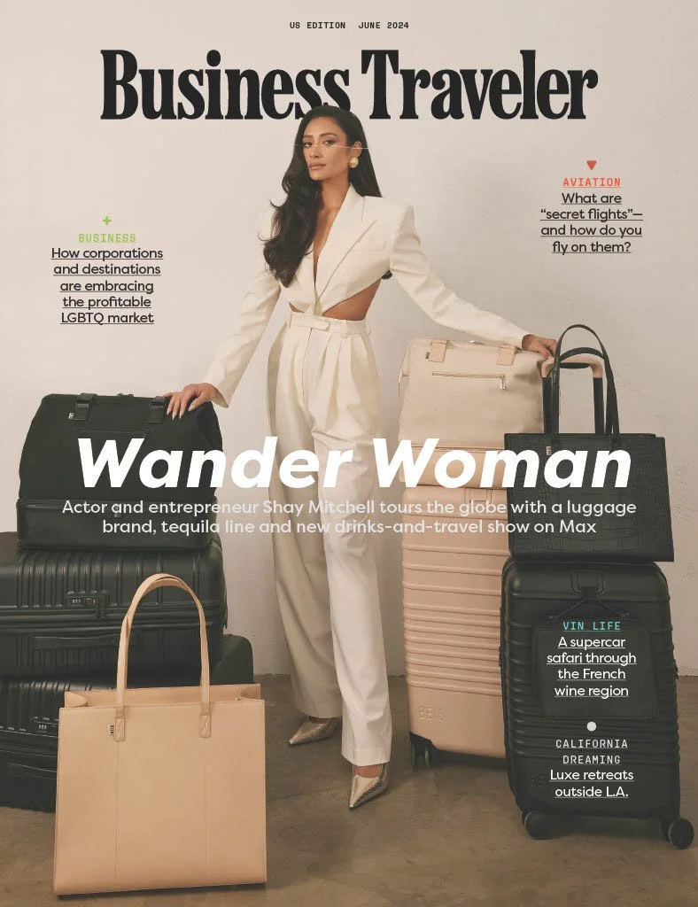 Cover of Business Traveler magazine, June 2024 issue, featuring a woman in white suit with large luggage and handbags, with headlines about travel, LGBTQ market, secret flights, a supercar safari, and luxe retreats.