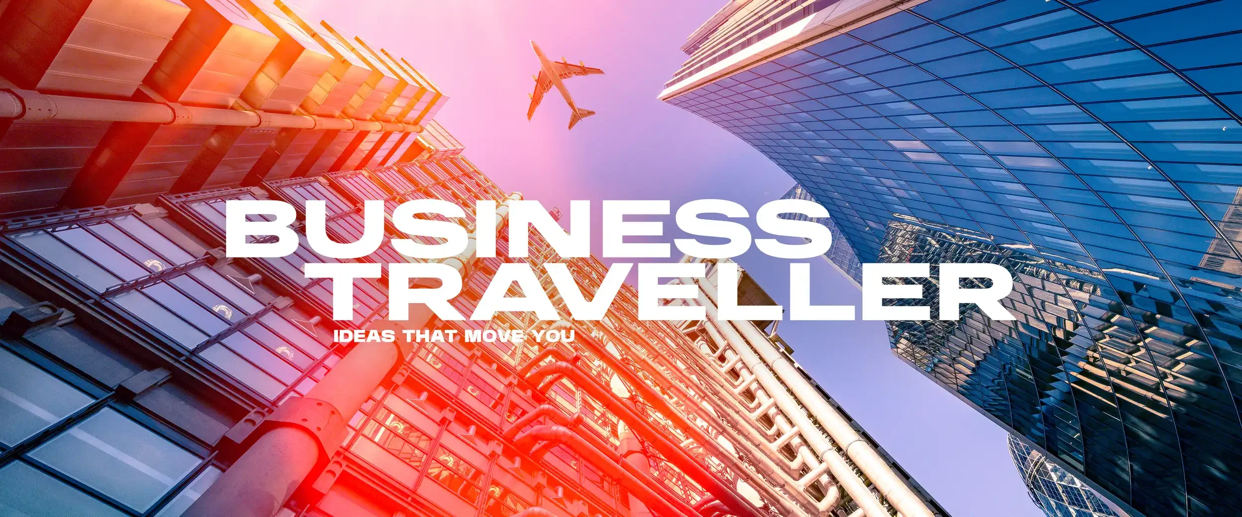Looking up at tall modern skyscrapers with glass facades in a city, with an airplane flying overhead. The text overlay says 'Business Traveller' and 'Ideas That Move You'.