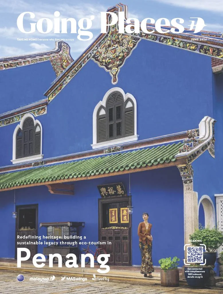 Cover of 'Going Places' magazine, June 2024, featuring a vibrant blue building with traditional Chinese architectural elements, including green tiled roof, decorative trim, and arched windows. A woman in traditional attire stands near the entrance, with greenery and a QR code in the foreground.