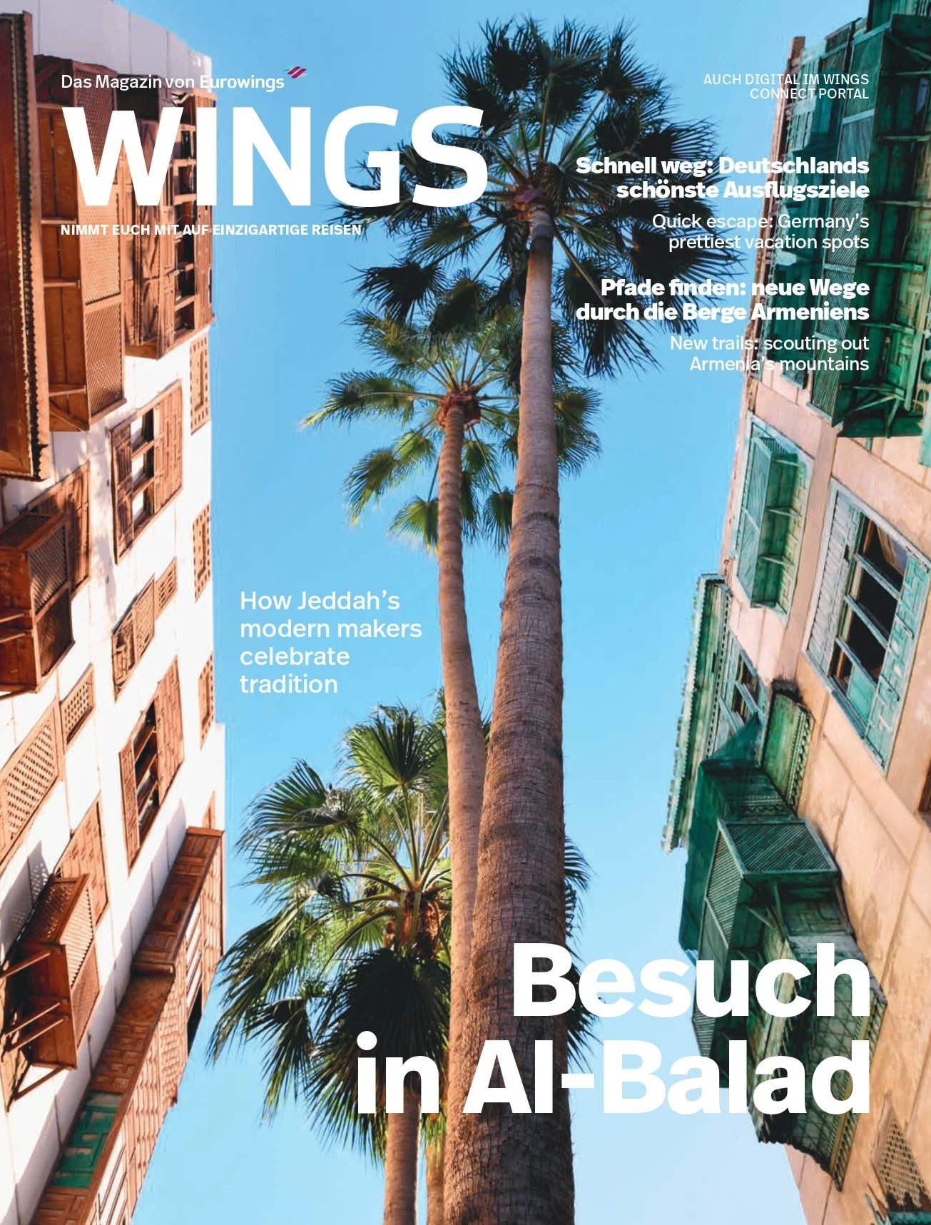 Cover of a magazine featuring a shot looking up at tall palm trees between buildings with blue sky background. The magazine title is 'WINGS', and it includes headlines about travel and culture in multiple languages.