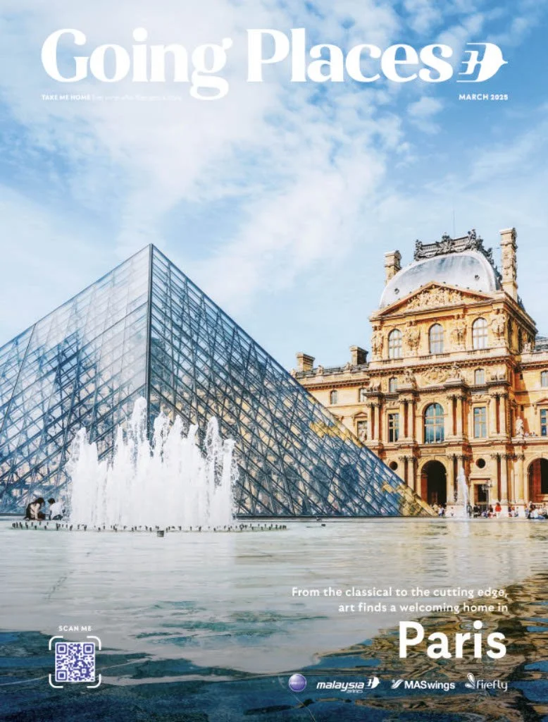Cover of a magazine titled 'Going Places,' March 2023, featuring the Louvre Museum and its glass pyramid in Paris with a fountain in the foreground and a cloudy sky in the background.