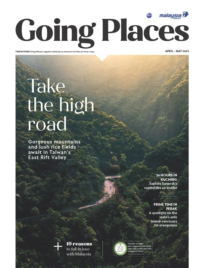Landscape photo of lush green mountains and rice fields in Taiwan's East Rift Valley with sunlight filtering through clouds