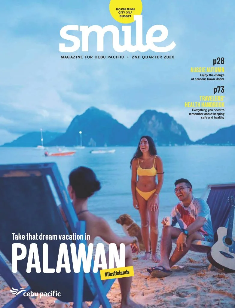 Cover of Smile magazine featuring a group of young friends enjoying a beach scene in Palawan, Philippines, with mountains in the background, a woman in a yellow bikini standing and two people sitting relaxed on beach chairs, one with a dog and a guitar, during sunset or twilight.