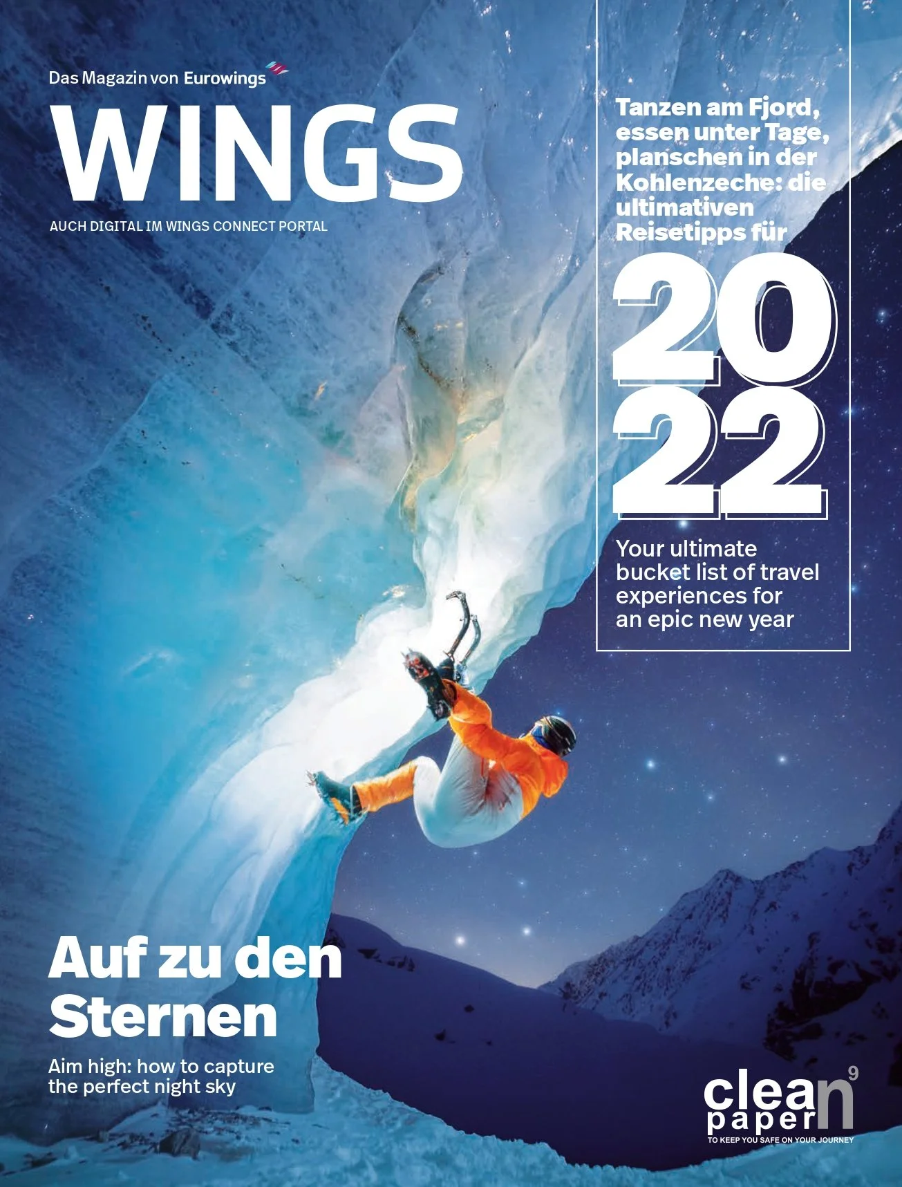 Magazine cover titled "WINGS" featuring a climber scaling an ice formation in a snowy mountain landscape at night. The cover includes headlines about travel experiences and stargazing tips for 2022.