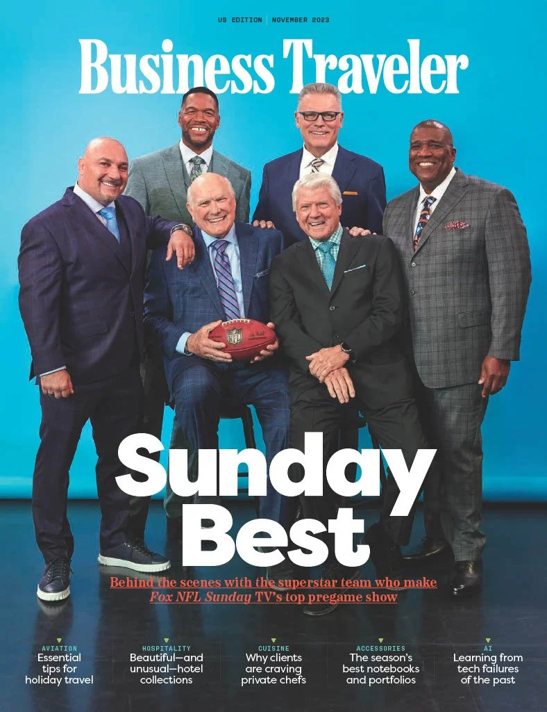 Cover of Business Traveler magazine, November 2023 issue, featuring seven men in suits posing together, with one holding an NFL football, on a blue background with the headline 'Sunday Best' and smaller text about NFL TV pregame show.
