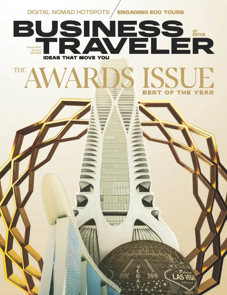 Cover of Business Traveler magazine featuring a modern architectural building with a unique design and geometric gold framework, promoting the awards issue for the best of the year.