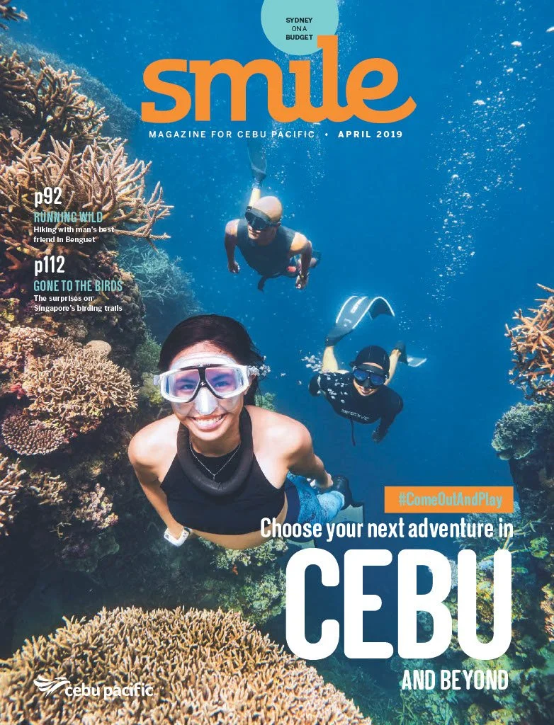 Cover of Smile magazine April 2019 featuring three people snorkeling underwater near a coral reef in Cebu, Philippines.