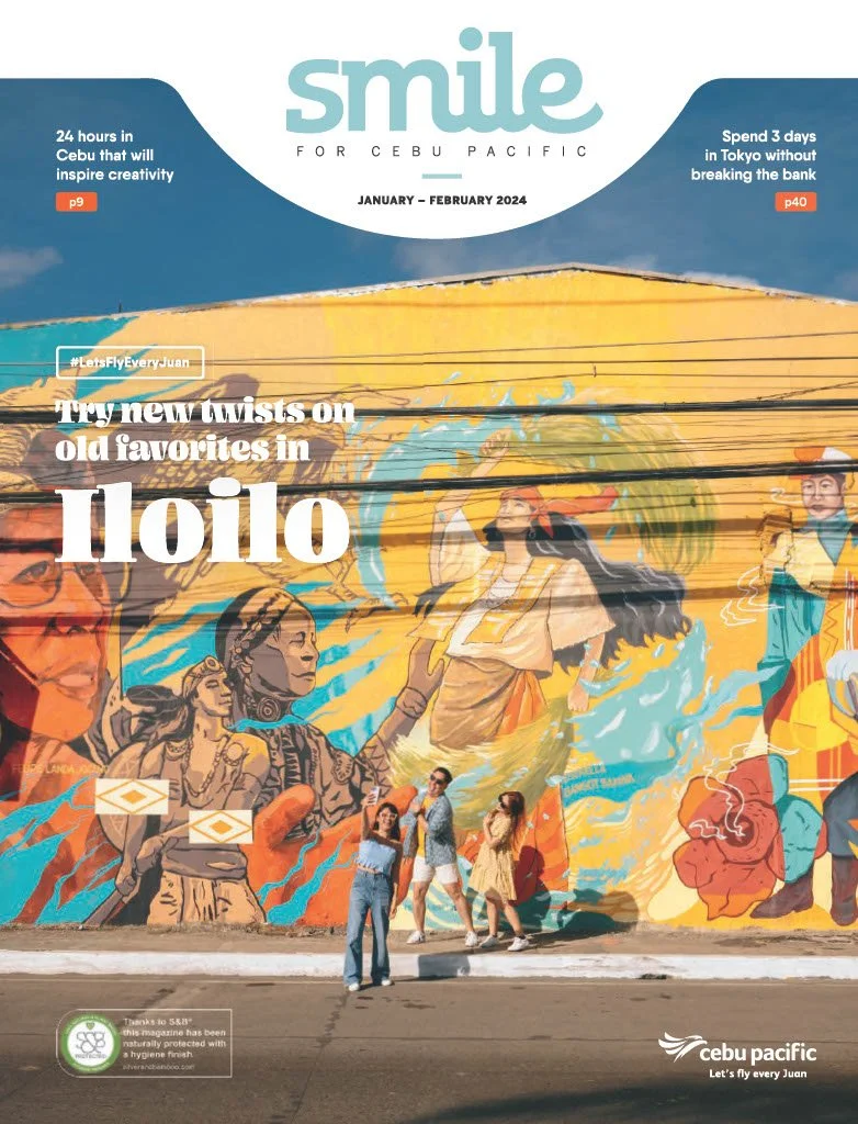 A colorful mural on a wall in Cebu Pacific highlights Filipino culture with images of traditional attire, dancers, and symbols. Four people are standing in front of the mural, taking photos, with the magazine's cover text overlayed.