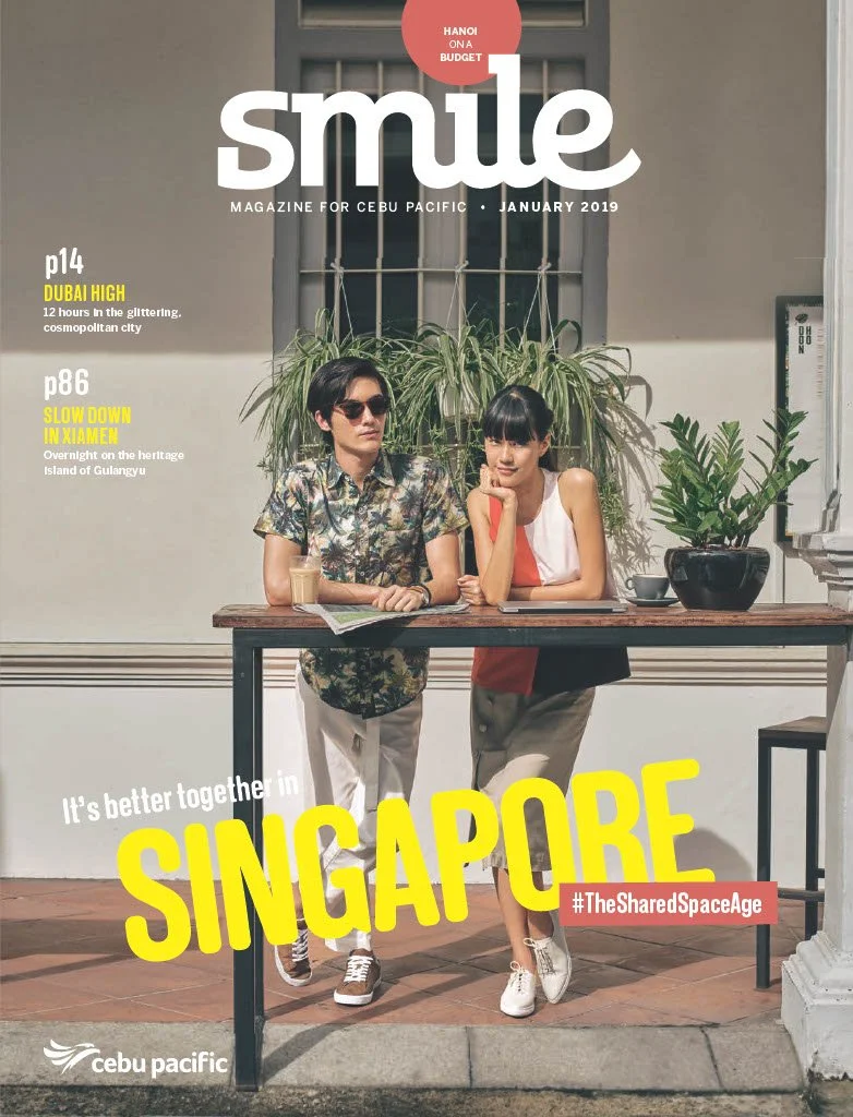 Cover of Cebu Pacific magazine titled 'Smile' from January 2019 featuring a young man and woman standing at a table outdoors with potted plants, a window, and white walls in the background.