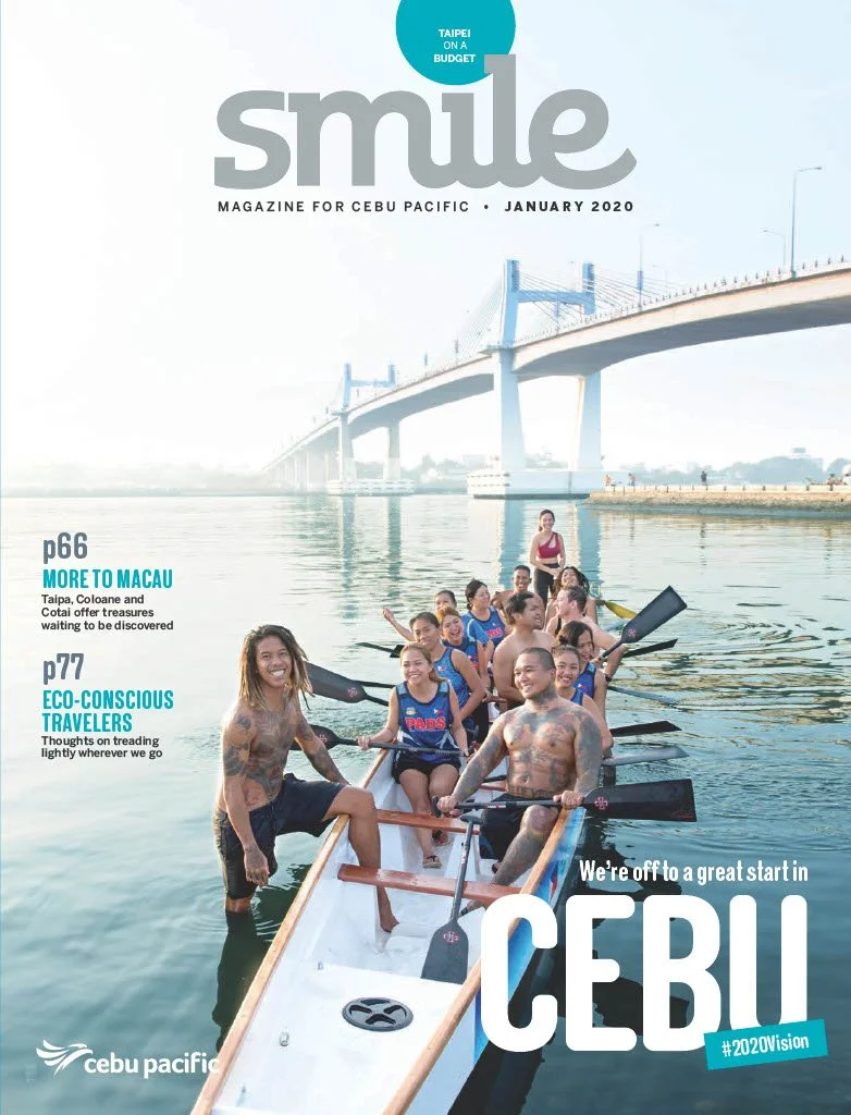 Cover of Cebu Pacific's January 2020 magazine featuring a group of people, some with tattoos, smiling and paddling a boat on a river under a bridge with a cityscape in the background.
