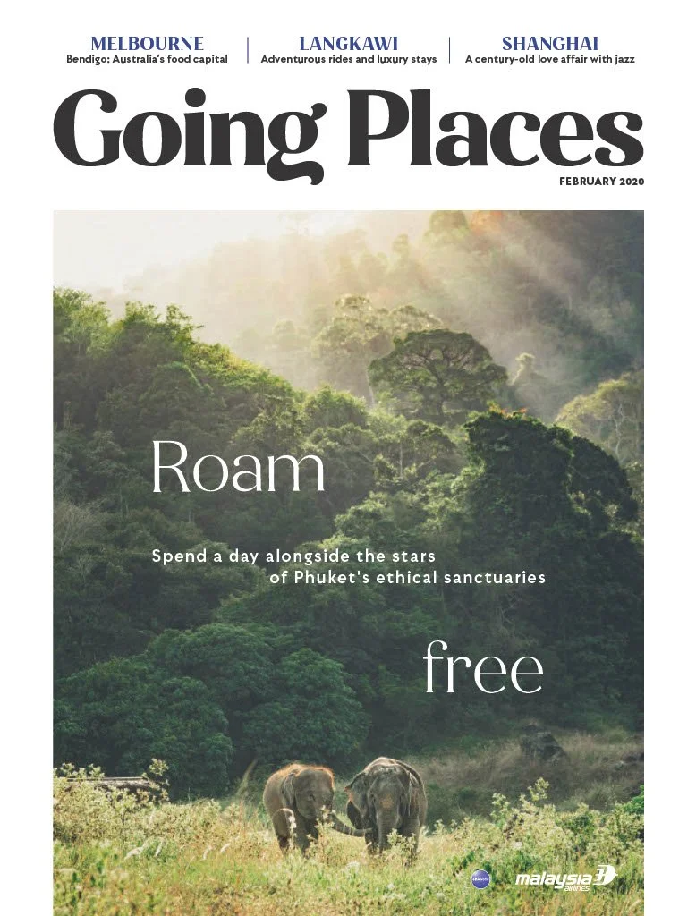 Magazine cover titled "Going Places" from February 2020, featuring a lush jungle landscape with two elephants walking through tall grass, and the words "Roam" and "free" overlaid. The cover highlights travel destinations in Melbourne, Langkawi, and Shanghai, and promotes ecotourism in Phuket, Malaysia.