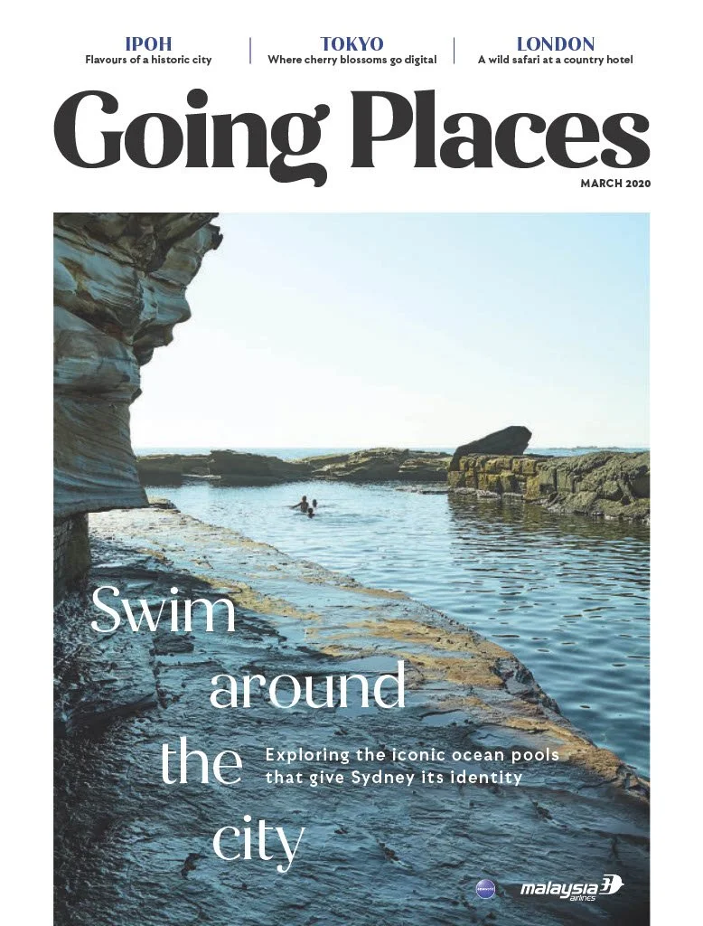 A magazine cover titled "Going Places" with a beach scene featuring rock formations and a person swimming in the ocean, promoting exploration of iconic ocean pools in Sydney.