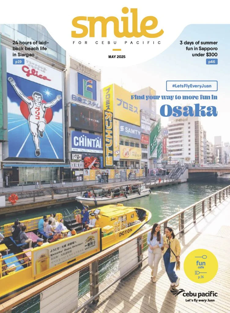 Bustling canal scene in Osaka with yellow sightseeing boats, pedestrians walking along the riverside, and colorful city billboards in the background.