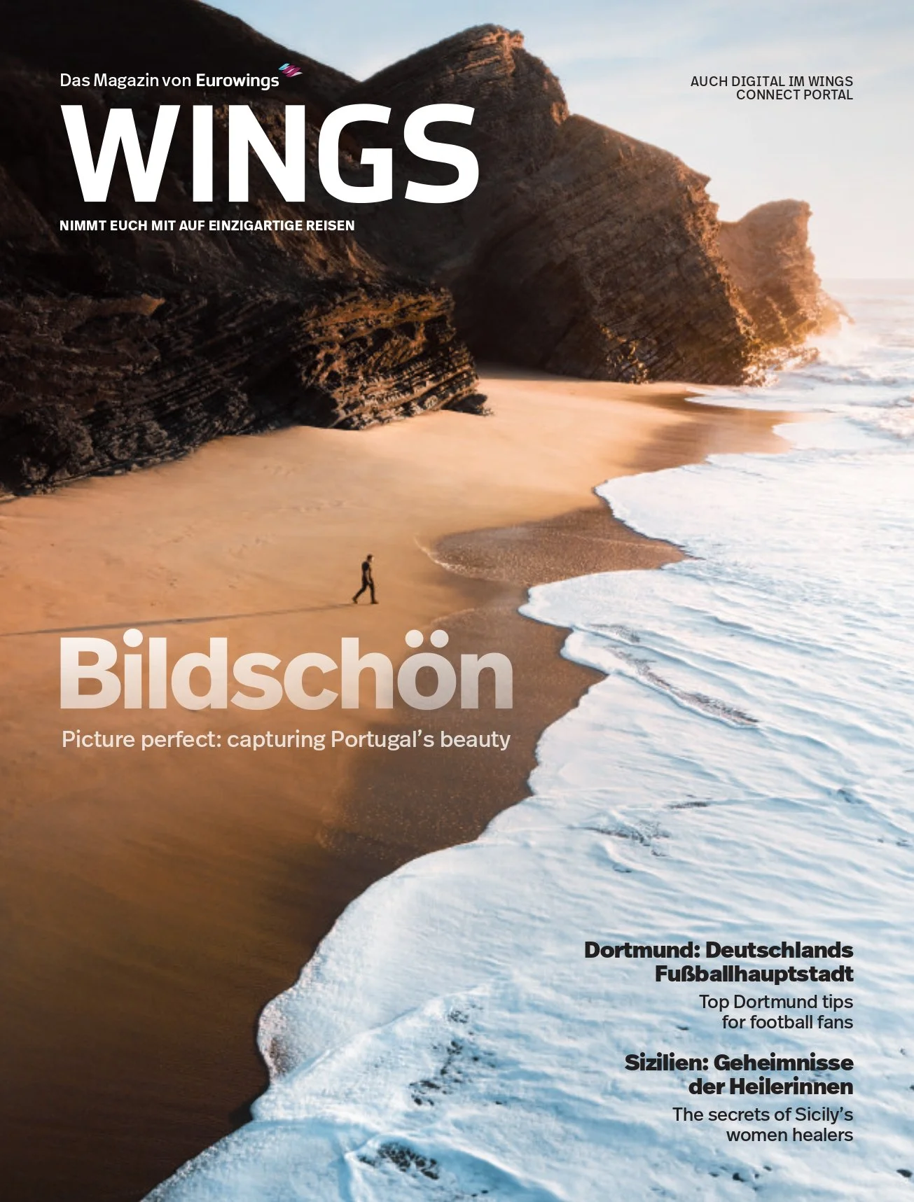 Magazine cover featuring a beach with sand, waves, and large rocky cliffs at sunset or sunrise, with a person walking along the shoreline.