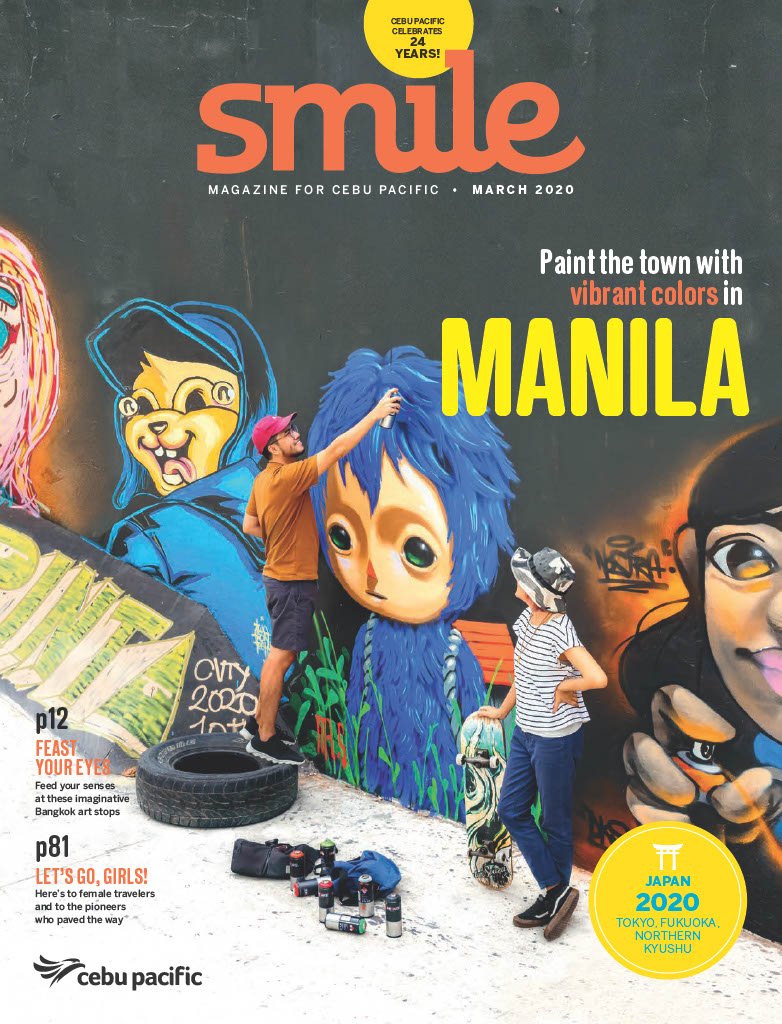 Cover of Smile magazine for Cebu Pacific, March 2020, featuring a mural art scene with two young men painting a colorful mural on a wall. One man is standing on a tire, using spray paint, while the other holds a skateboard. The mural depicts a girl with blue hair and large eyes, among other vibrant characters. There are spray paint cans and other art supplies on the ground.