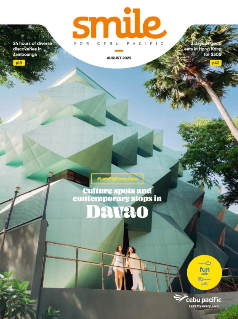 Cover of Smile magazine, August 2025 issue, featuring a modern geometric building, two women walking on a platform, and tropical trees, with headlines about discoveries in Zamboanga and Hong Kong, and a yellow circle indicating a café section.