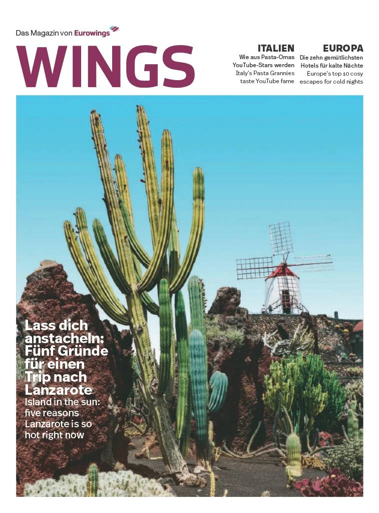 Cover of WINGS magazine, featuring large cacti against a bright blue sky, a traditional windmill, and rocks. The magazine focuses on Lanzarote, Spain, with headlines about Italy and Europe.