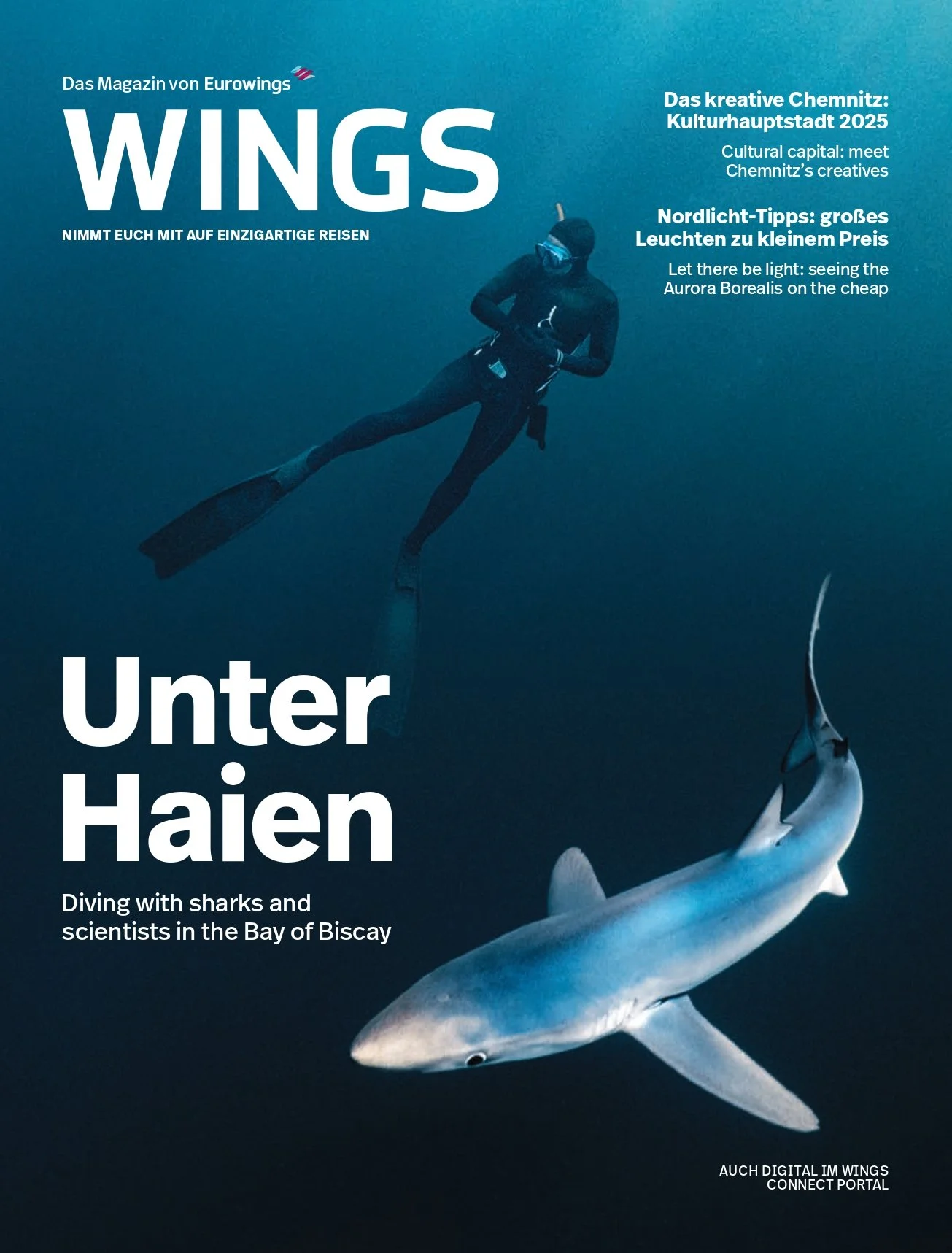 Cover of a magazine titled 'WINGS' showing a diver underwater next to a shark in the Bay of Biscay.