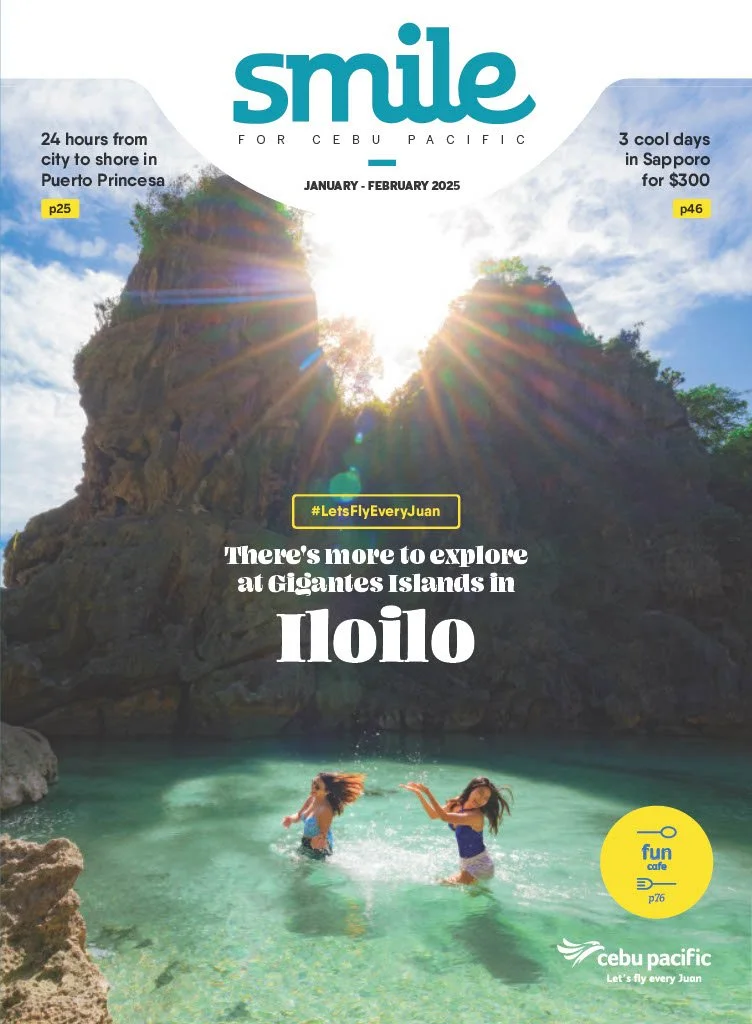 Tourists swim in clear water at Gigantes Islands, with rocky cliffs and the sun shining through the sky.
