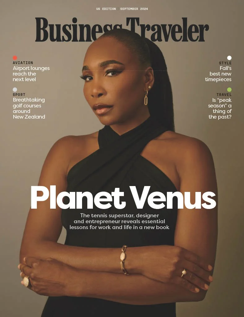 Cover of Business Traveler magazine, September 2024 edition, featuring a woman with a black sleeveless top and gold jewelry, standing with arms crossed. The magazine includes articles on aviation, sport, style, and travel, with headlines highlighting airport lounges, golf courses in New Zealand, fall fashion, and peak travel seasons. The main headline introduces Venus, a tennis superstar, designer, and entrepreneur.