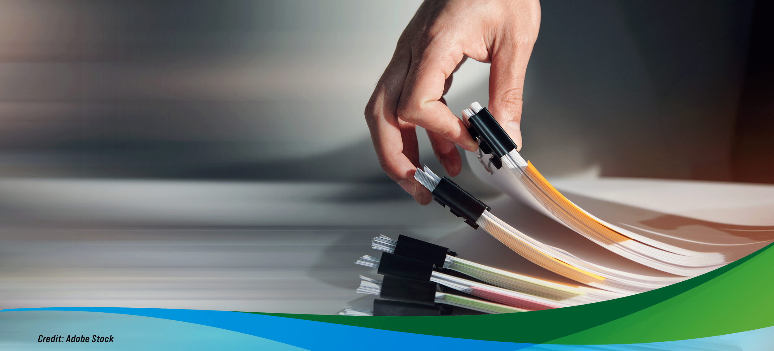 A person sorting through a set of documents