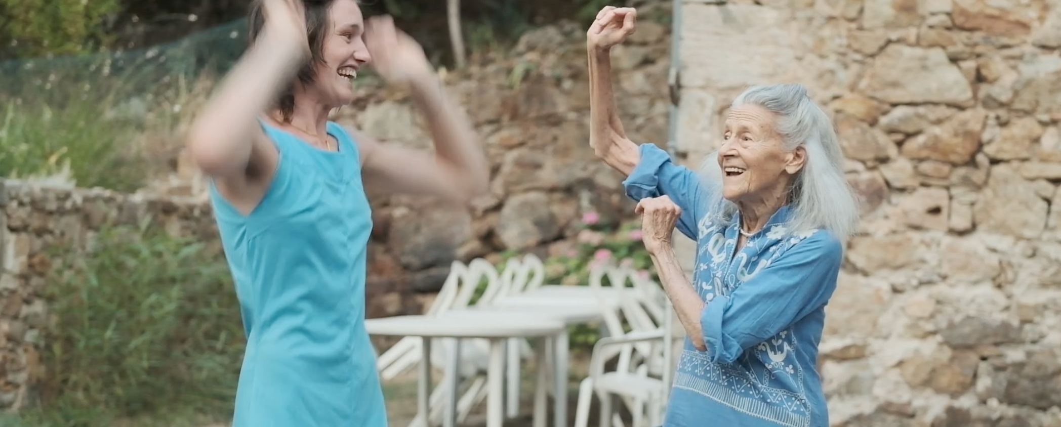 Rosa Cotton and Kaya Anderson, founder member of the Roy Hart Theatre dancing happily in the courtyard in Malérargues.