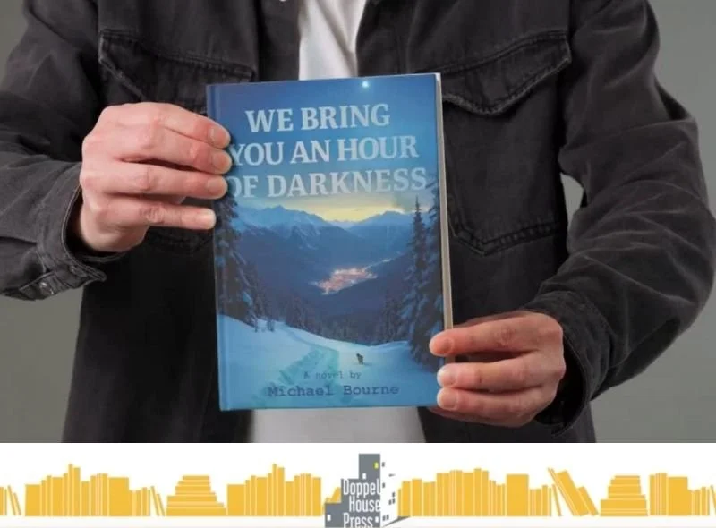Person wearing a black jacket holding a book titled 'We Bring You an Hour of Darkness' by Michael Bourne in front of a plain background.