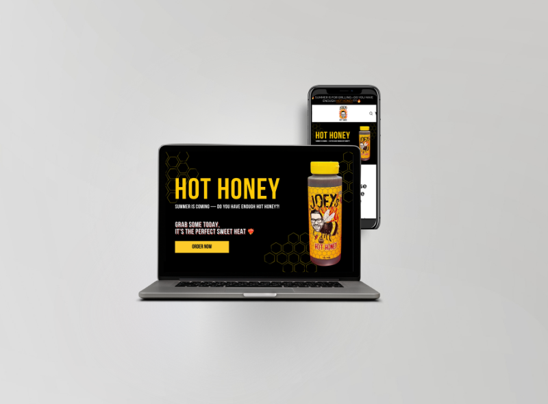 Laptop displaying an advertisement for Joey's Hot Honey with a jar of hot honey and a smartphone showing the same product page.