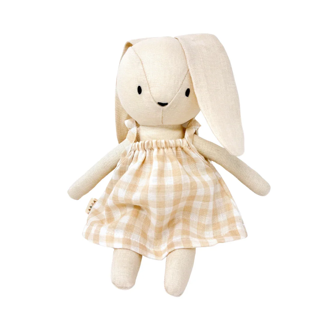 A plush toy rabbit with long ears wearing a beige checkered dress.