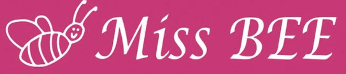 Pink background with a simple white line drawing of a smiling bee and the words "Miss BEE" in white cursive font.