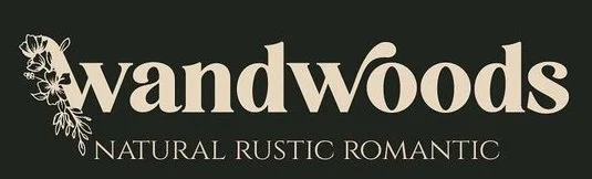 Logo with the word "wandwoods" and the subtitle "natural rustic romantic" underneath, featuring a floral design on the left side.