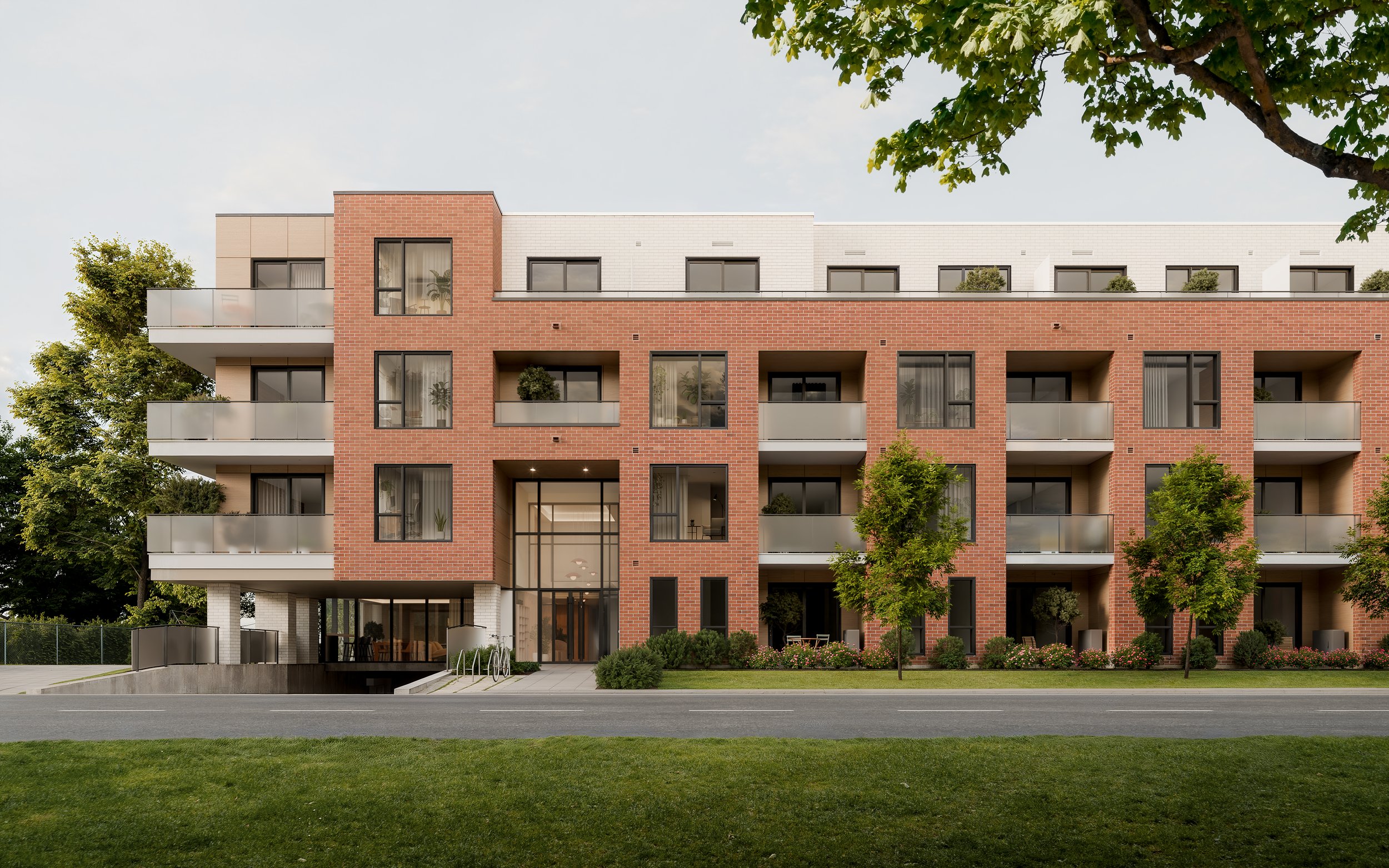 Exterior view of the Boisé Boisé apartment building in Bois-Franc, with brick façade, large glass entrance, and balconies