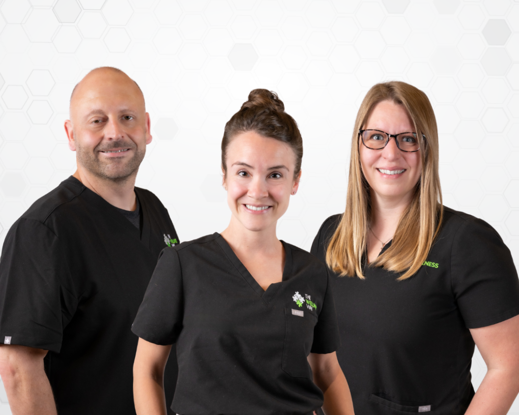 Three health restoration coaches wearing black scrubs smiling at the camera, standing against a plain white background.