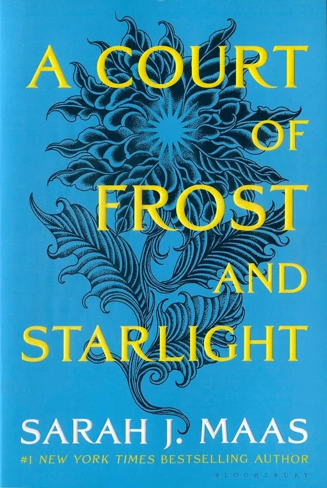Book cover titled "A Court of Frost and Starlight" by Sarah J. Maas with a blue background and intricate floral design in darker blue.