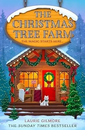 A holiday-themed bookstore display with a wooden sign reading 'The Christmas Tree Farm' and a subtitle 'The magic starts here.' The scene includes a cozy wooden cabin decorated with Christmas wreaths and garlands, surrounded by snow, with a small whi