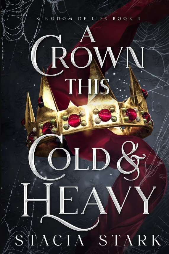 Book cover for 'A Crown This Cold & Heavy' by Stacia Stark, from the Kingdom of Lies series, Book 3. The cover features a gold crown adorned with red and silver jewels, set against a dark background with cobwebs.