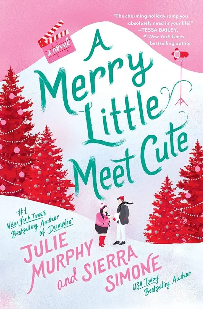 Book cover titled 'A Merry Little Meet Cute' by Julie Murphy and Sierra Simone, featuring red Christmas trees, a pink snowy background, and an illustration of a woman and man talking, with a clapperboard labeled 'a novel' at the top.
