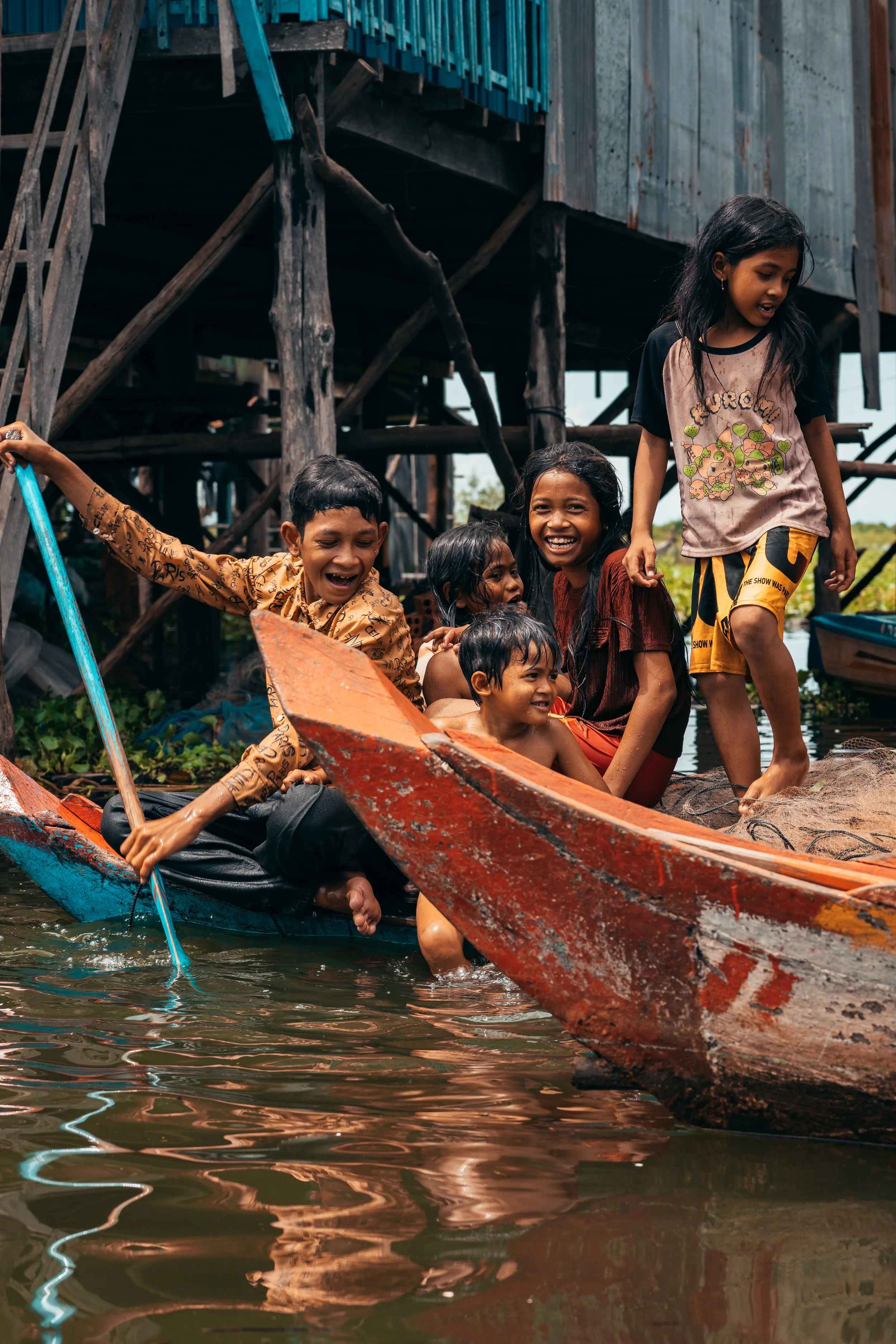 A group of children enjoying themselves on a boat in Kompong Phluk, Cambodia