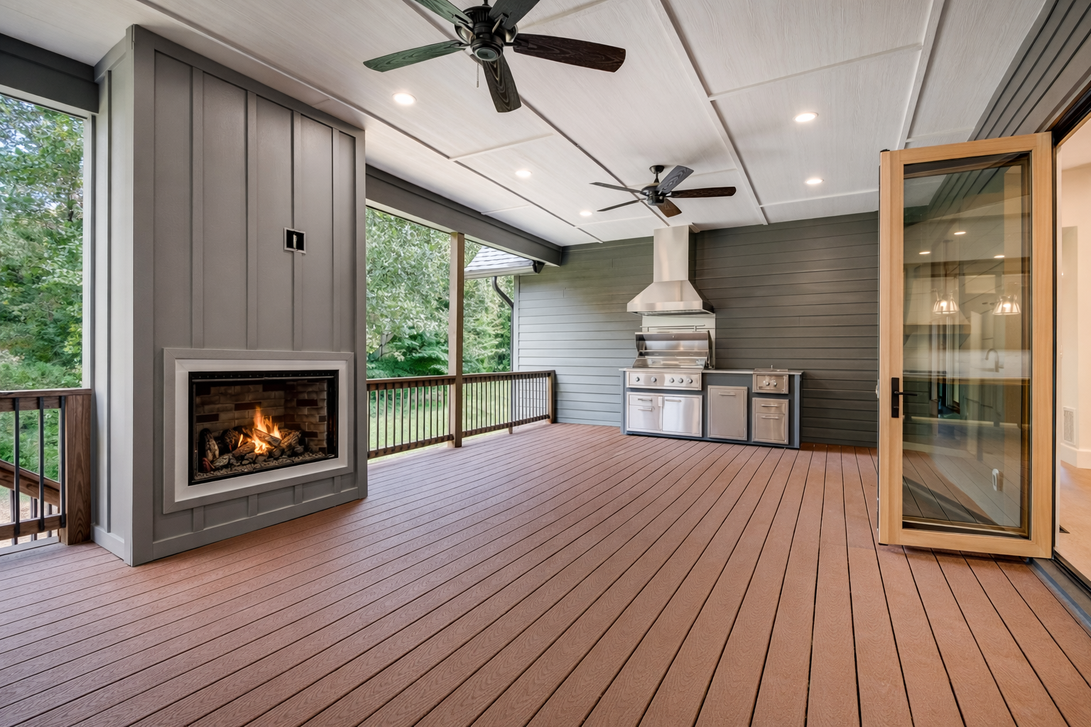 Covered outdoor porch with wood flooring, a built-in fireplace, ceiling fans, and a grill area, next to a sliding glass door.