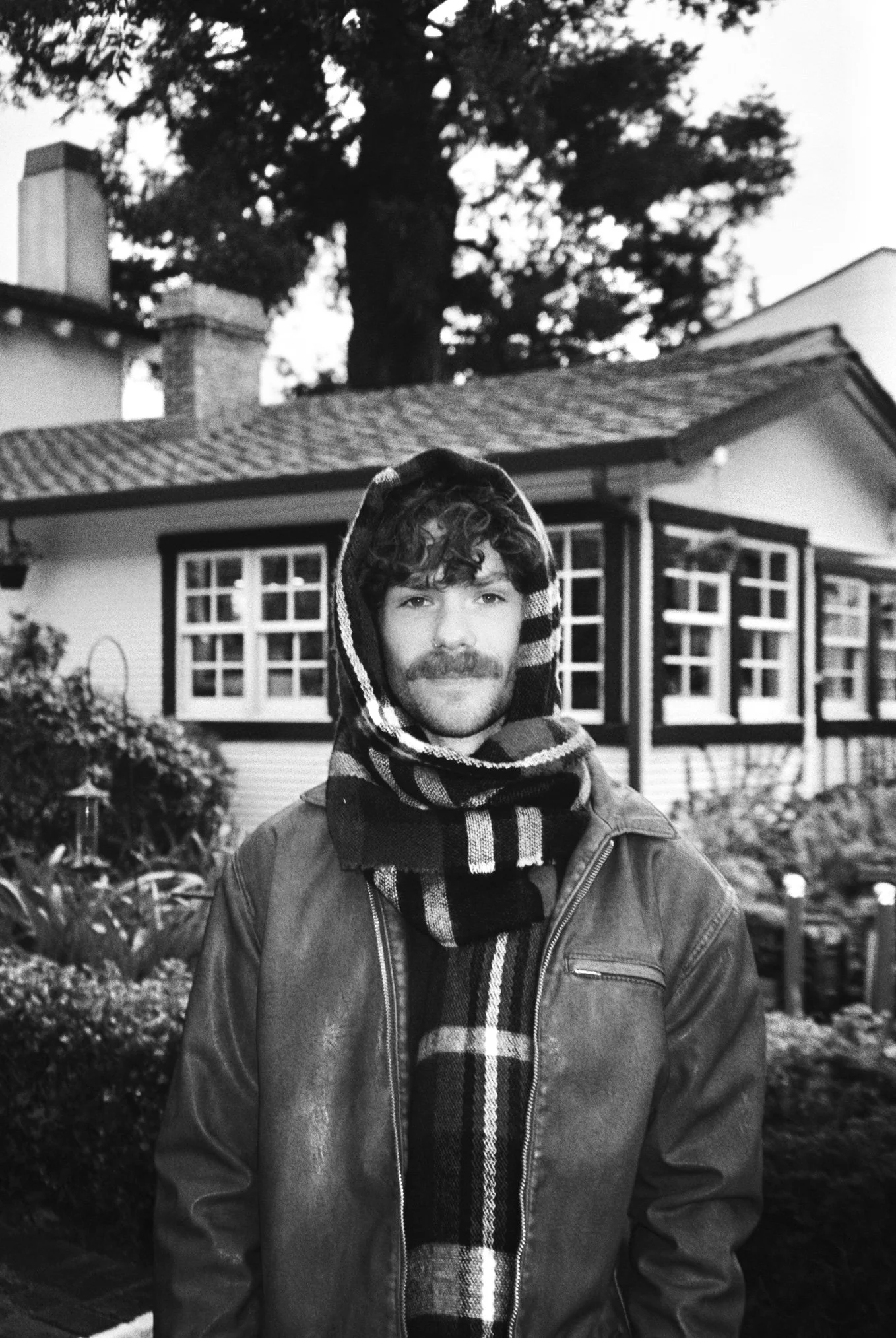 A man with a mustache in black and white