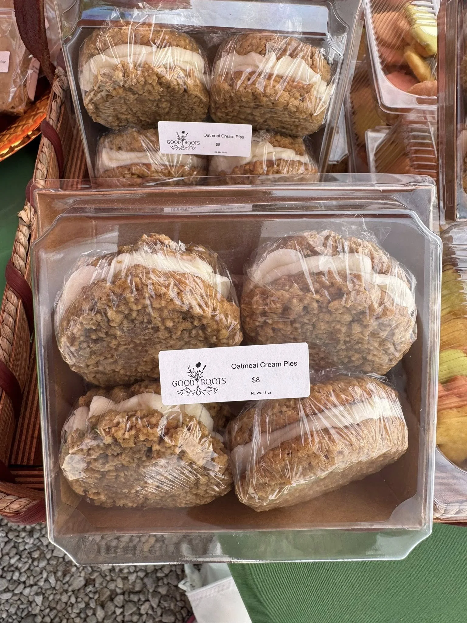 Clear plastic container with four oatmeal cream pies, labeled 'Good Roots, Oatmeal Cream Pies, $8'.