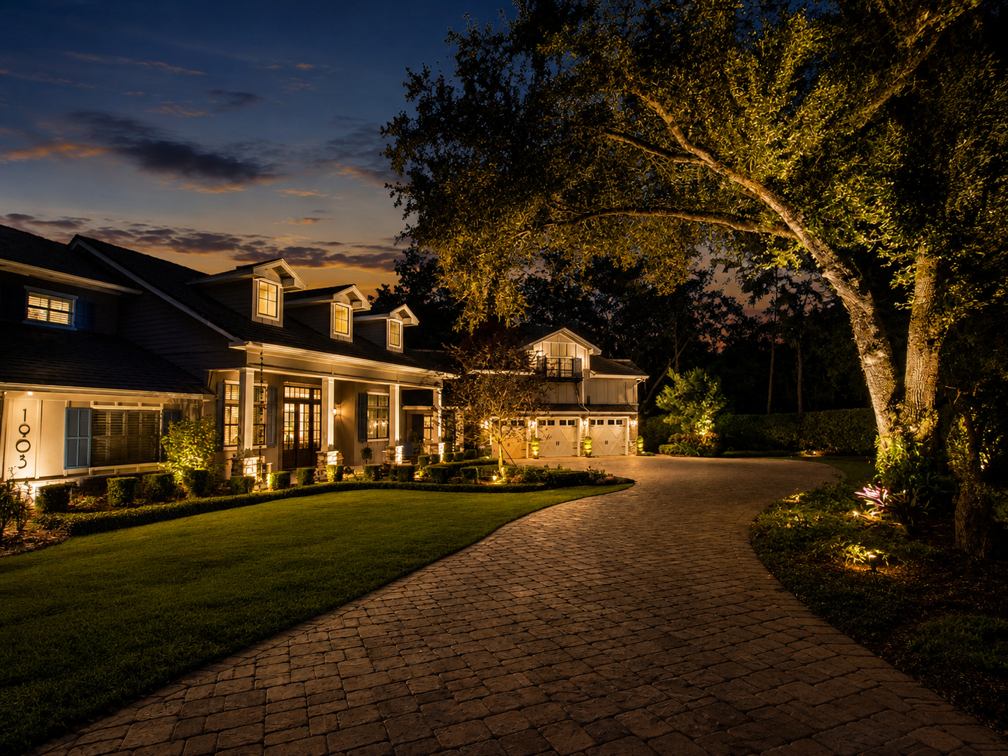 winter haven home with landscape lighting of trees and plants and walls by Vibe Lighting