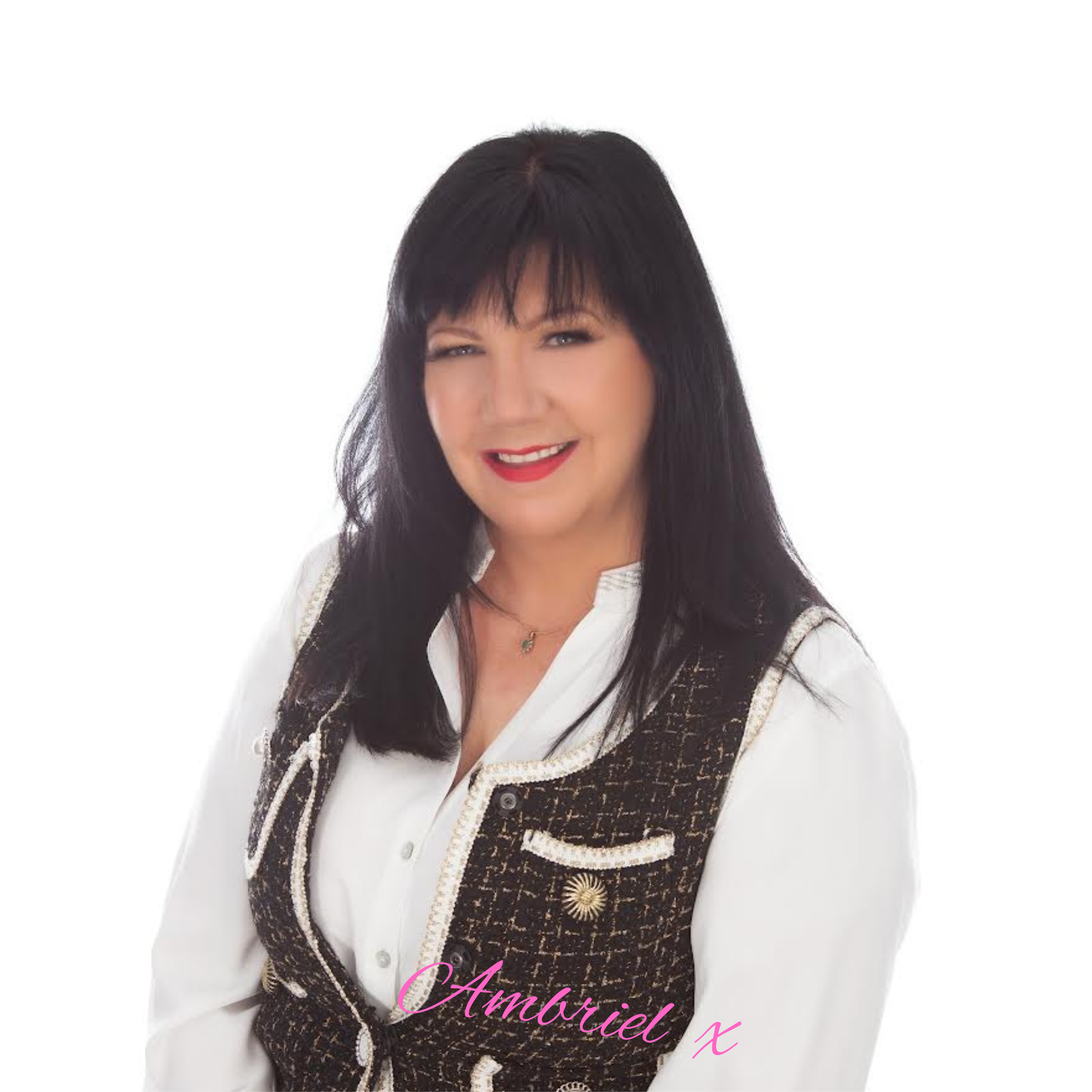 A woman with black hair wearing a white blouse and a dark, patterned waistcoat with decorative trim, smiling at the camera against a white background with the text 'Ambriel X' in pink at the bottom.